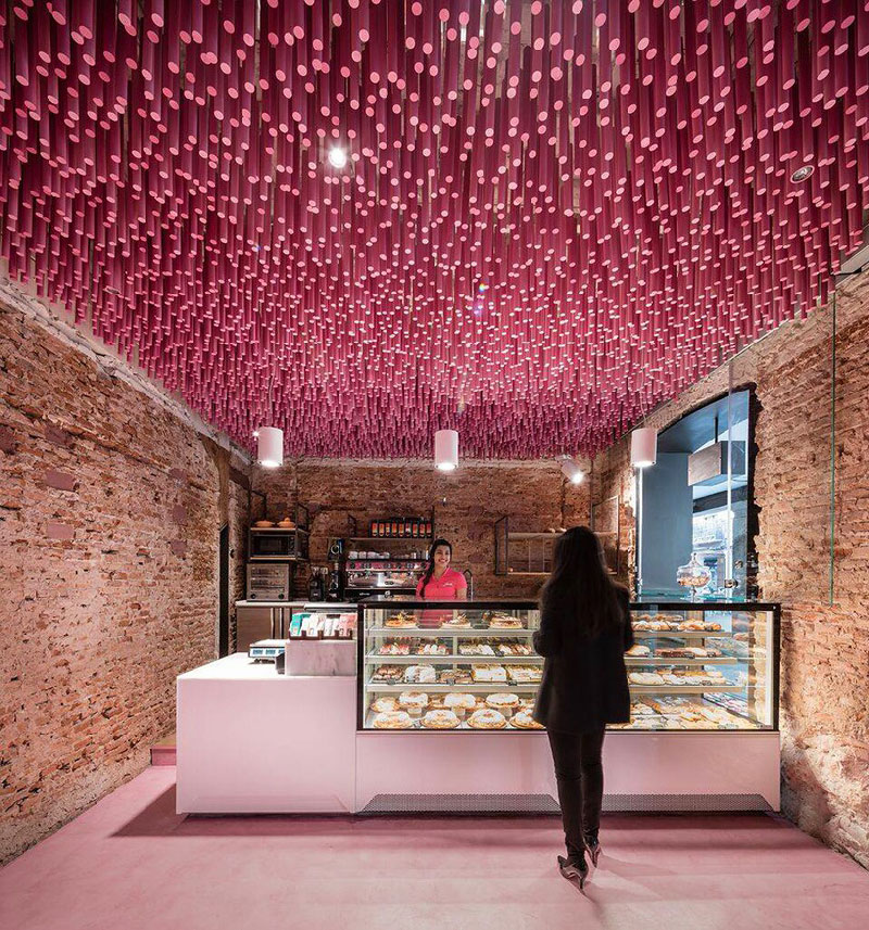 lady standing in pink patisserie makes her mouth water